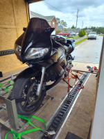 A motorcycle secured inside an enclosed transport trailer, showcasing professional motorcycle transport services